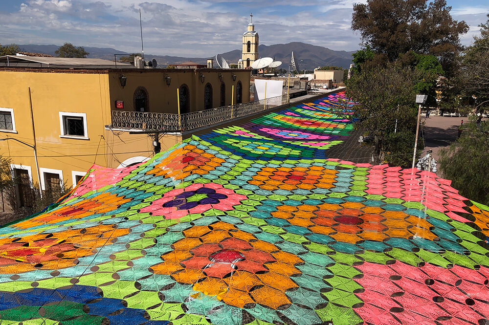 woven fabric hangs over streets