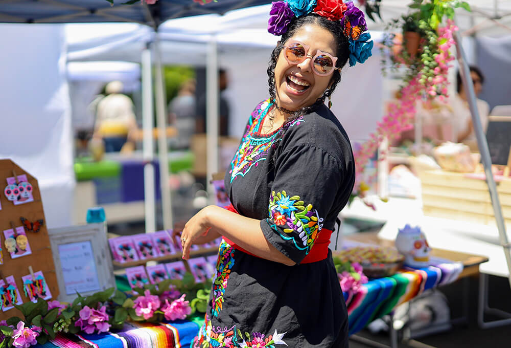 woman in colorful costume at outdoor market