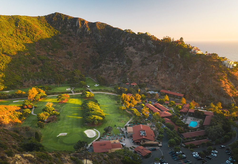 golf course surrounded by mountains